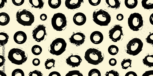 Abstract pattern of black brushstrokes resembling organic shapes and circles