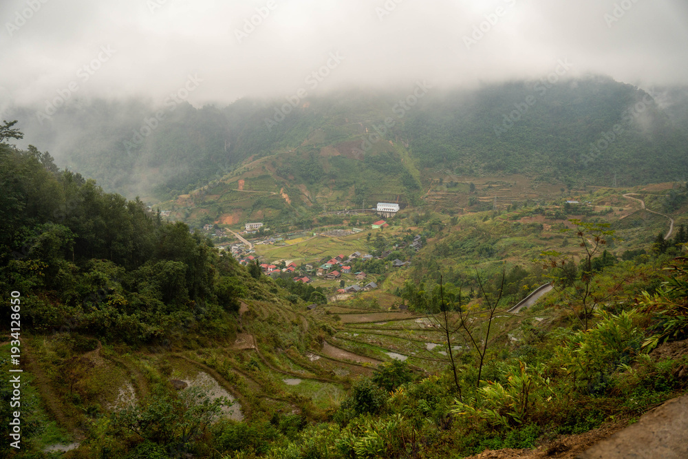 Fototapeta premium Small village in a misty valley