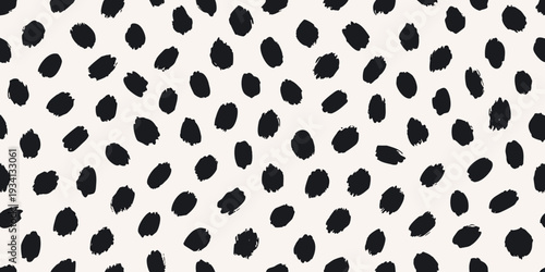 Abstract black brushstroke pattern on a cream colored background