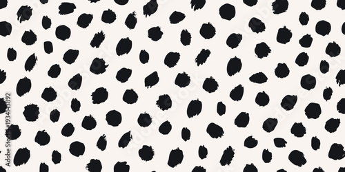 Abstract black spots on a cream colored background a seamless pattern