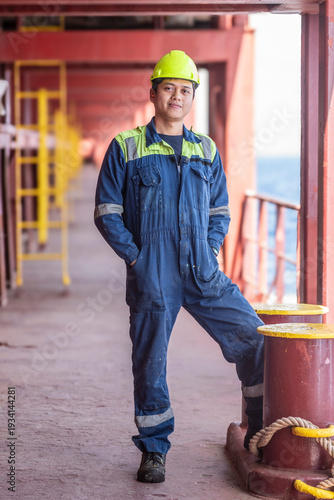 Engine room specialist outside on ship deck, representing modern commercial shipping industry.