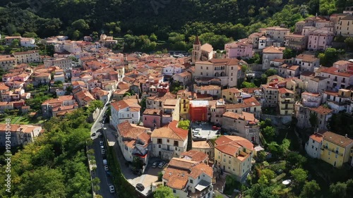 Scenic aerial view of Maratea with traditional terracotta rooftops and colorful buildings nestled in lush green hills in southern Italy.