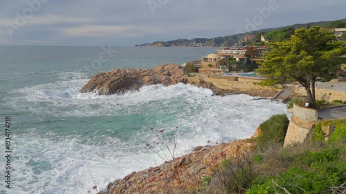 Rough sea waves crashing on the rocky coast of sant feliu de guixols