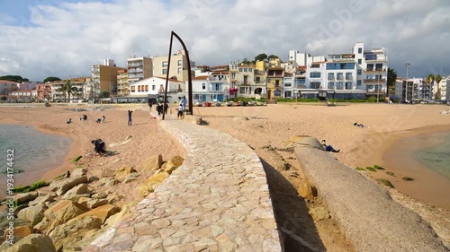People relaxing on blanes beach in costa brava