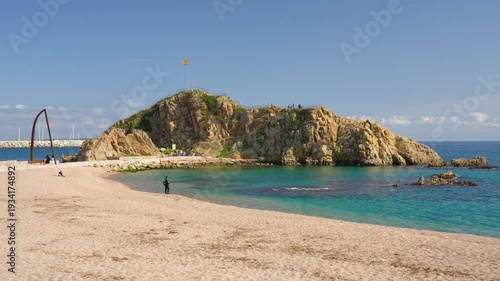 Sa palomera rock on sandy blanes beach in costa brava