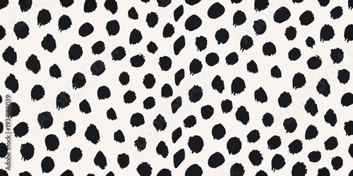 Seamless pattern of irregular black spots on a cream background
