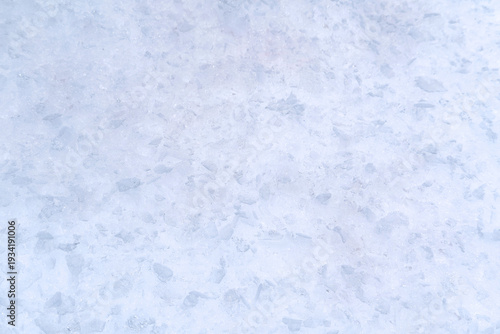 Close up of shimmering crushed ice pieces forming a sparkling frosty blue and white texture background