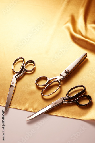 Tailor’s Scissors on Golden Satin Fabric