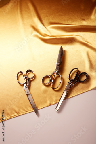 Tailor’s Scissors on Golden Satin Fabric