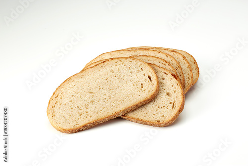 Obraz na płótnie Freshly cut wheat bread slices on white background