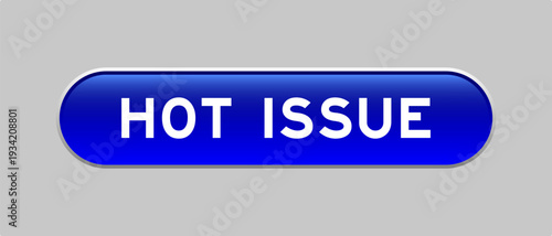 Blue color capsule shape button with word hot issue on gray background