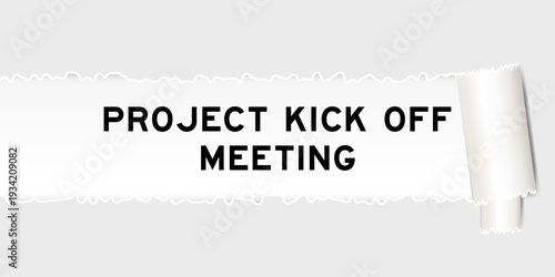 Ripped gray paper background that have word project kick off meeting under torn part