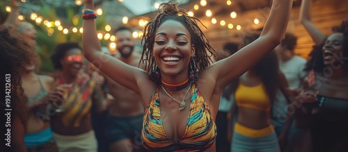 Woman dancing joyfully at outdoor party; friends celebrate