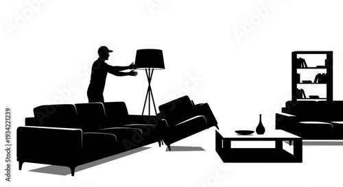 Silhouette of man arranging furniture in a living room