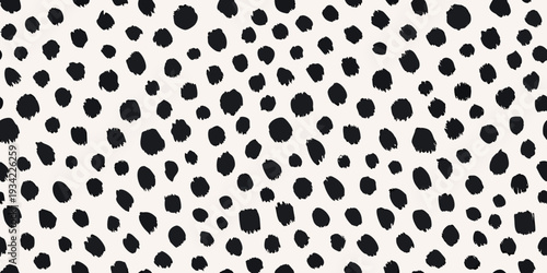 A seamless pattern featuring irregular black spots on a cream background