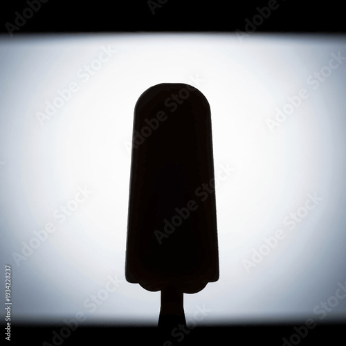 Silhouette of a classic popsicle on a stick.