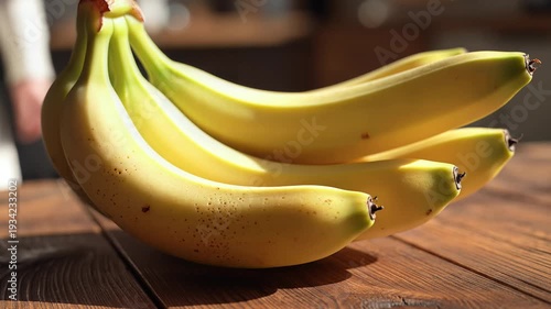 Close up of ripe bananas on wooden surface in natural light