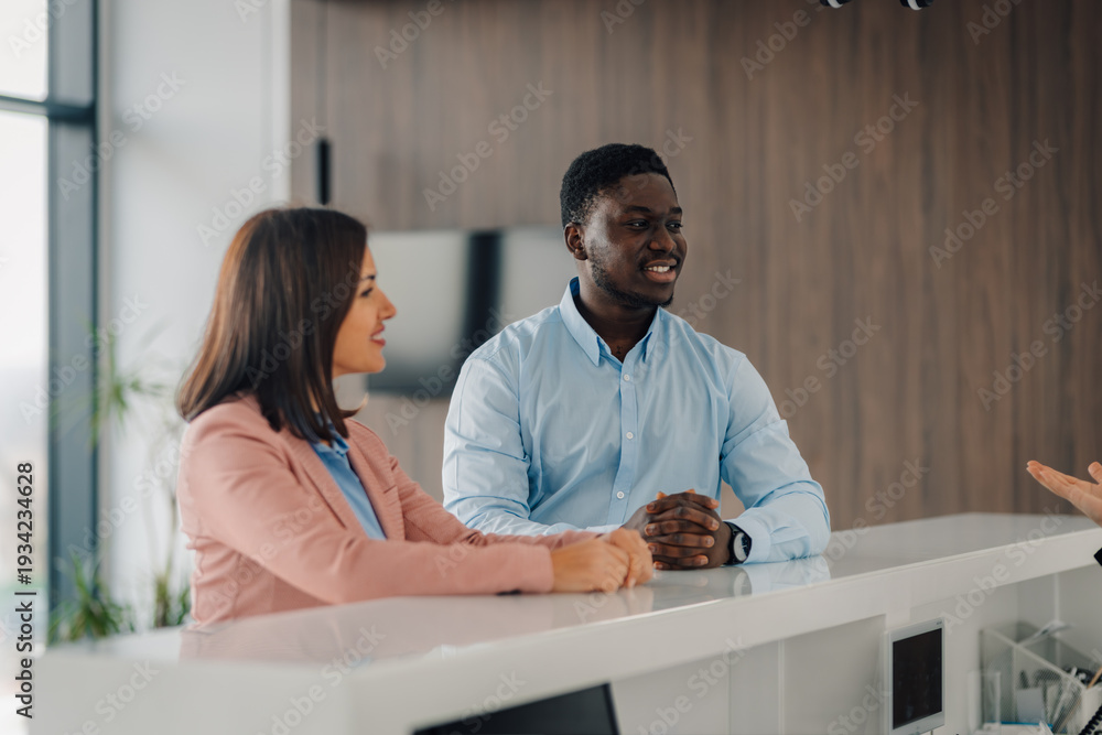 Fototapeta premium Business people interacting at office reception desk