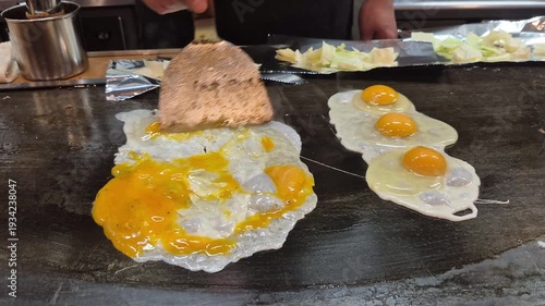 Cooking eggs on Japanese iron plate teppanyaki style