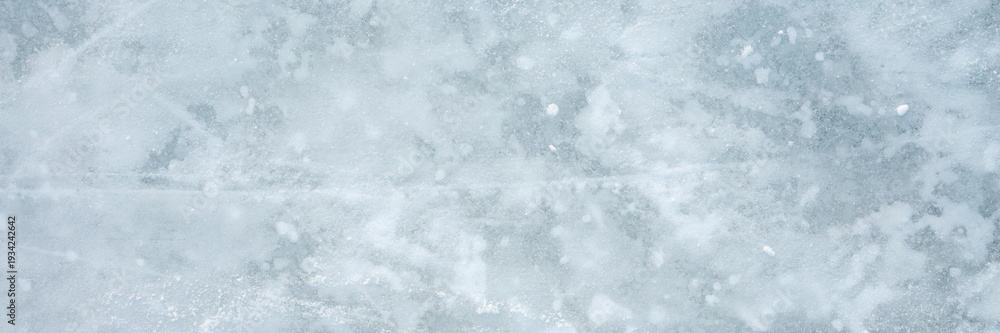 Fototapeta premium Snowy ice background. Closeup. Wide banner. Top down view.