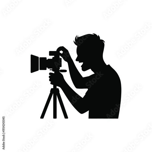 Silhouette of a photographer taking a picture with a camera on a tripod