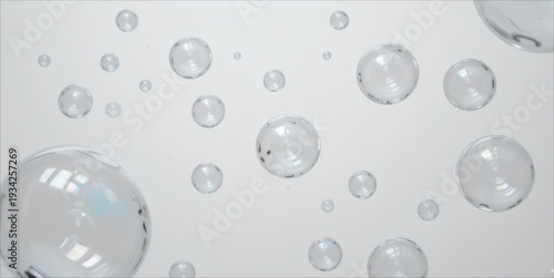 Floating transparent spheres and bubbles on a clean, bright background. 3D render.