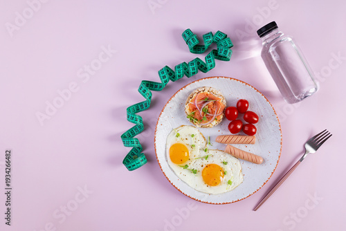 Fried eggs with sausage, cherry tomatoes and buckwheat bread with salmon fish