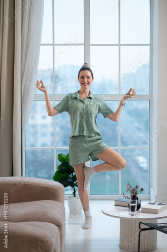 Free Download Woman standing in a tree pose and keeping balance - GFXLoad