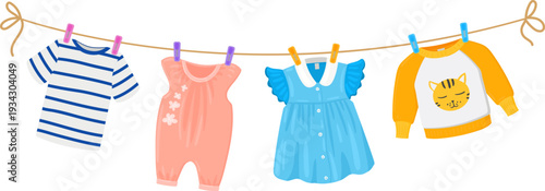 Baby clothes hanging on a clothesline drying laundry