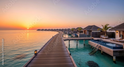 Wooden pier with villas over turquoise water at sunset