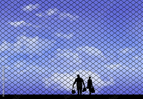 Stopped at the border are a man and a woman with luggage. A chainlink fence halts their progress in this illustration.