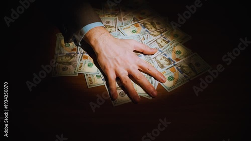 closeup shot man hand rakes in pile of money dollar bills. person takes bribe income, salary profit. Money making, success, wealth concept large sum of cash wage dollars prize win. Hand male thief 4k