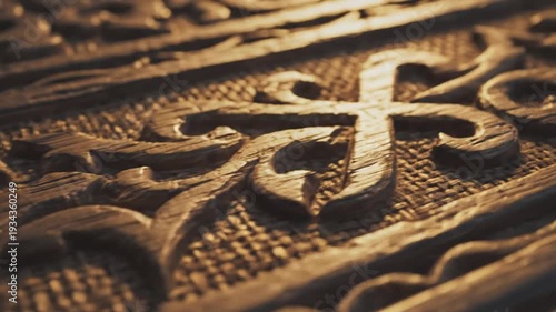Ornate carved wooden motif in warm sunset light showing engraved floral patterns