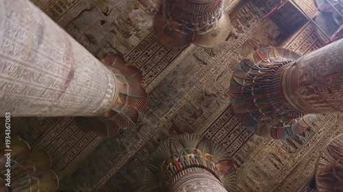 Egypt. Esna temple hypostyle hall with massive painted columns and colorful hieroglyphic reliefs on ceiling in Egypt, ancient Roman-era architecture with preserved pigments and carvings.