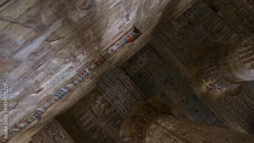 Egypt. Esna temple hypostyle hall with massive painted columns and colorful hieroglyphic reliefs on ceiling in Egypt, ancient Roman-era architecture with preserved pigments and carvings.