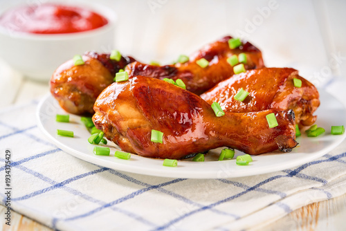 Wallpaper Mural Roast chicken drumsticks with sauce on a white table, selective focus. Torontodigital.ca