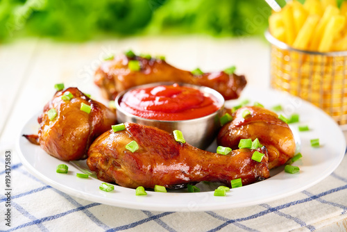 Wallpaper Mural Grilled chicken drumsticks with ketchup and french fry on a white wooden table. Torontodigital.ca