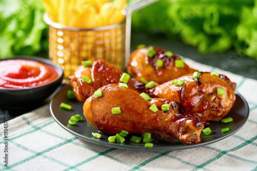 Wallpaper Mural Grilled chicken drumsticks with ketchup and french fry on a black table. Torontodigital.ca