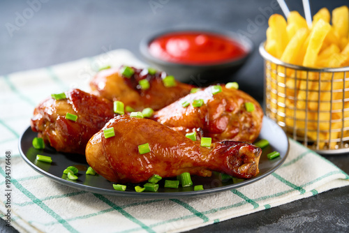 Wallpaper Mural Grilled chicken drumsticks with ketchup and french fry on a black table. Torontodigital.ca