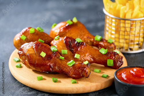 Wallpaper Mural Grilled chicken drumsticks with ketchup and french fry on a black table. Torontodigital.ca