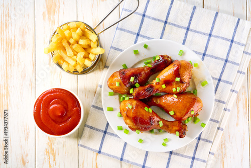 Wallpaper Mural Fried crispy chicken legs with ketchup and french fry on a white table, top view. Torontodigital.ca