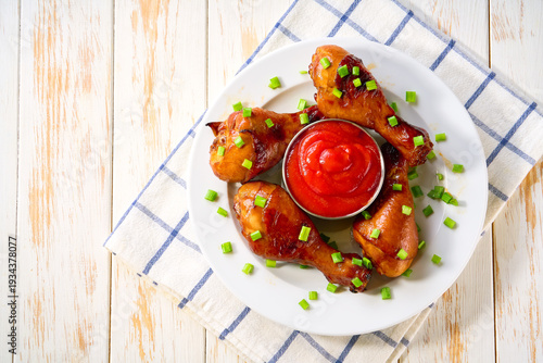 Wallpaper Mural Grilled chicken drumsticks with sauce on a white table, top view. Torontodigital.ca