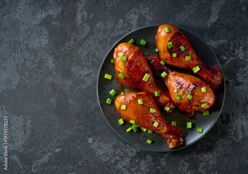 Wallpaper Mural Fried chicken legs with sauce on a black table, top view. Roast chicken drumsticks on a black table. Torontodigital.ca