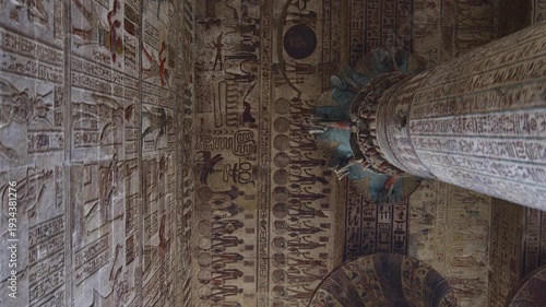 Egypt. Esna temple hypostyle hall with massive painted columns and colorful hieroglyphic reliefs on ceiling in Egypt, ancient Roman-era architecture with preserved pigments and carvings.