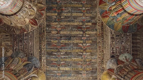 Egypt. Esna temple hypostyle hall with massive painted columns and colorful hieroglyphic reliefs on ceiling in Egypt, ancient Roman-era architecture with preserved pigments and carvings.