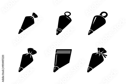 Collection of black pastry bags and piping nozzles on a white background