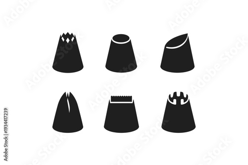 Set of six different black piping tips for cake decorating on a white background