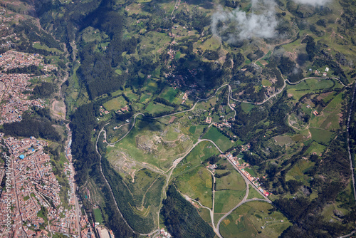aerial perspective,captured moments before landing at Alejandro Velasco Astete International Airport, offers a first glimpse of the rugged beauty and agricultural heritage surrounding Cusco, Peru. 