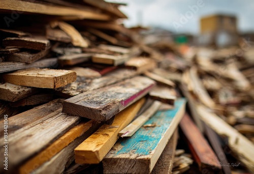 A close-up view of a pile of weathered, colorful, and broken wooden planks