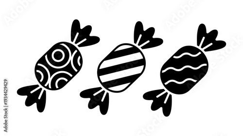 Three unique wrapped candy icons in black feature distinct decorative patterns on their wrappers.